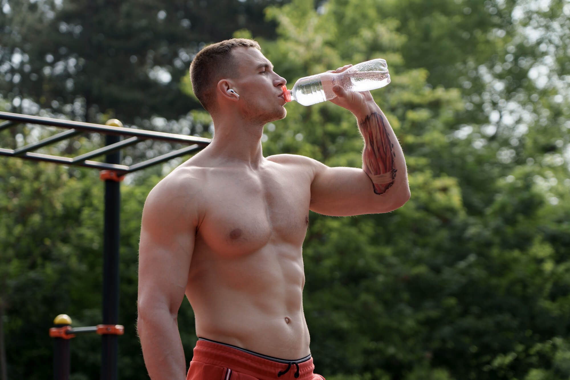 athletic man drinking electrolytes