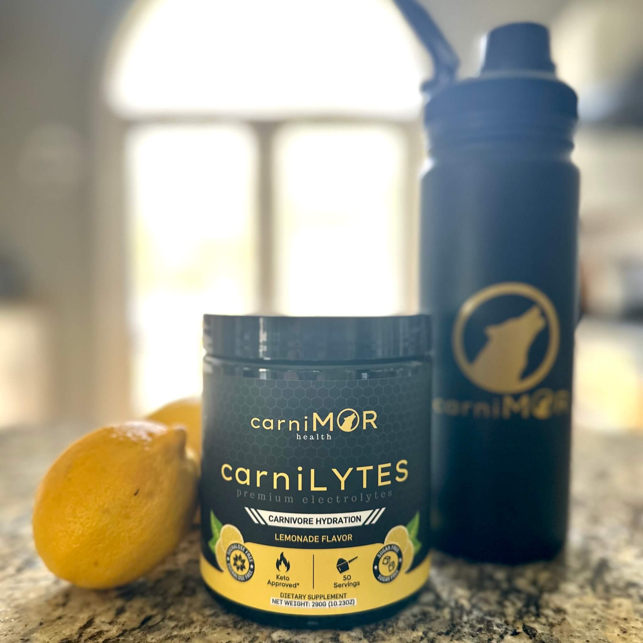 carniLYTES electrolyte powder with lemons and a water bottle on a kitchen counter