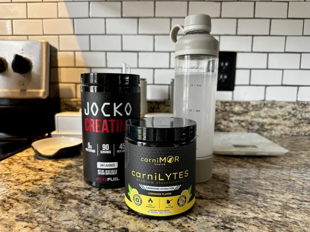 water bottle with containers of sugar free electrolytes and creatine